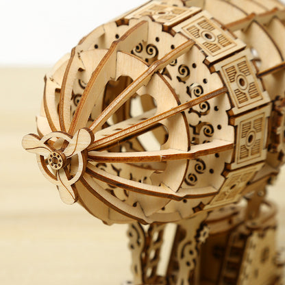 Wooden mechanical model with intricate details on a beige background