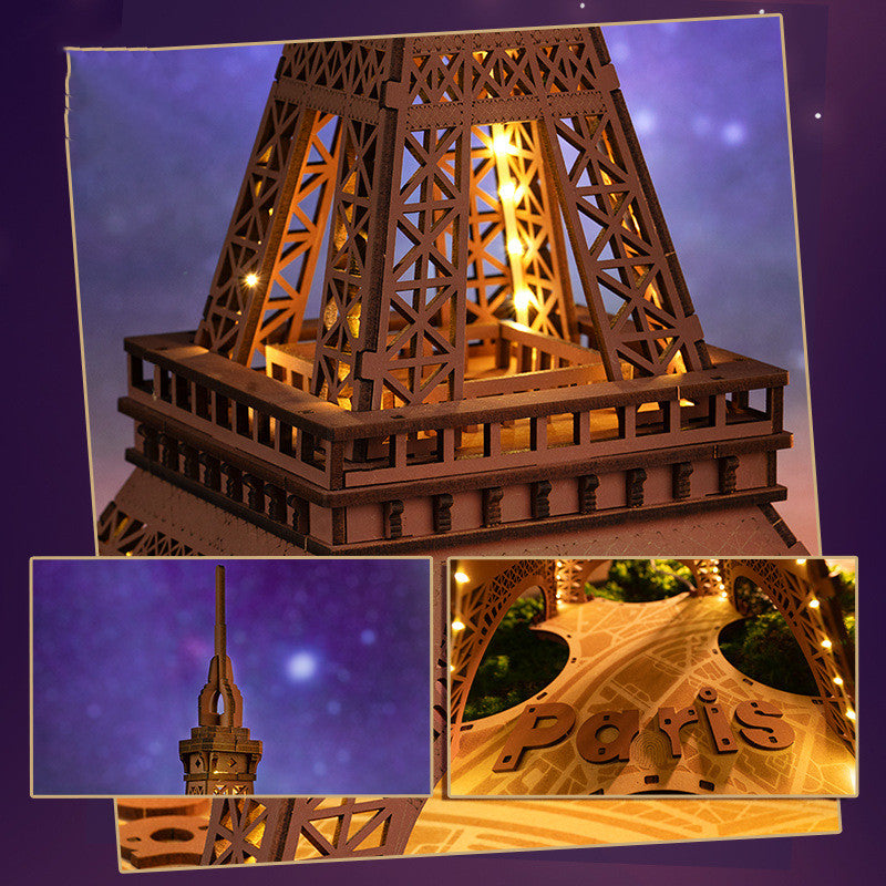 Wooden model of the Eiffel Tower with lights on a purple background