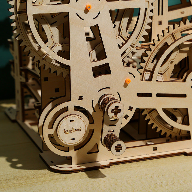 Wooden mechanical model with gears on a wooden surface