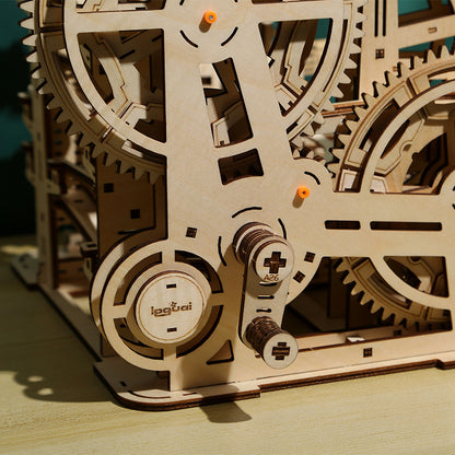 Wooden mechanical model with gears on a wooden surface
