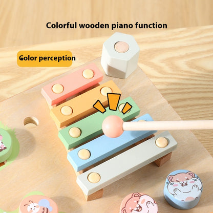 Colorful wooden piano toy with geometric shapes on a wooden surface