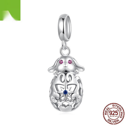 Silver pendant with a decorative design and gemstones on a white background, featuring 'Real Sterling Silver' stamp.