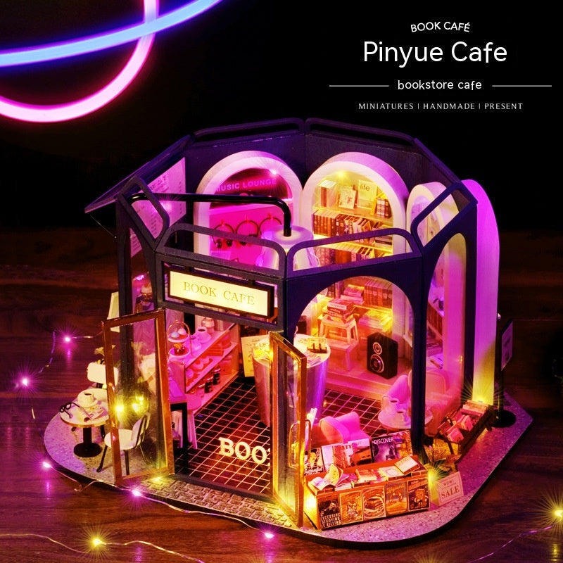 Miniature book-shaped cafe with interior lights on a dark background