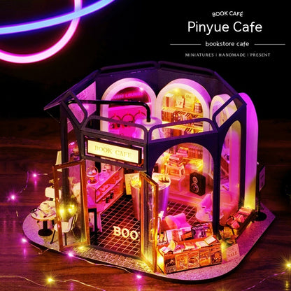 Miniature book-shaped cafe with interior lights on a dark background