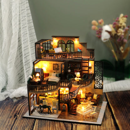 Detailed model of a house with interior furniture on a wooden surface.