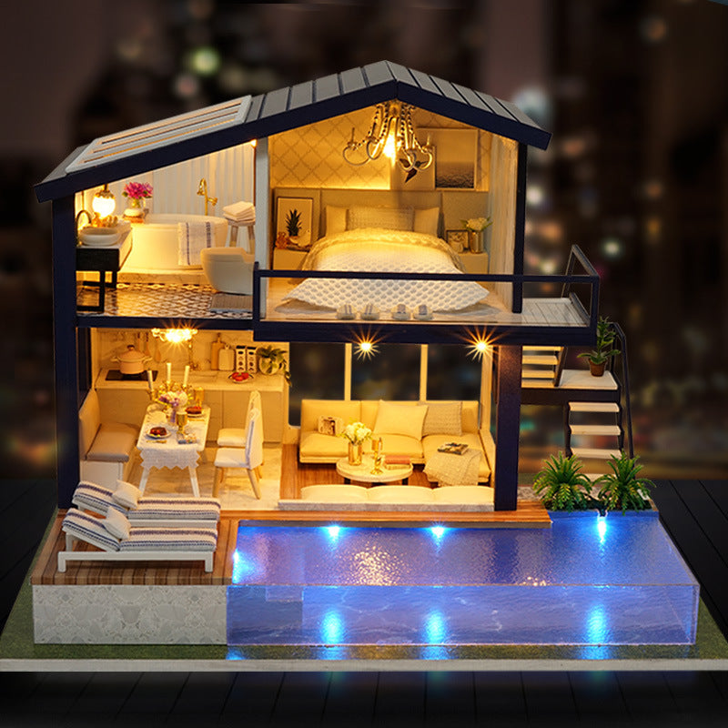 Model of a house with rooms illuminated, including a bedroom, living room, and kitchen.