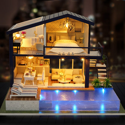 Model of a house with rooms illuminated, including a bedroom, living room, and kitchen.