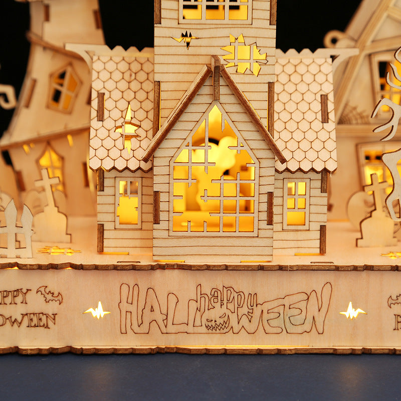 Wooden Halloween house model with glowing lights and 'Happy Halloween' text.
