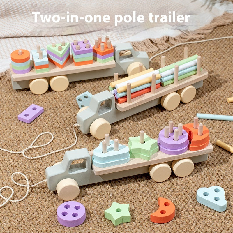 Wooden toy truck with trailer and colorful blocks on a textured surface