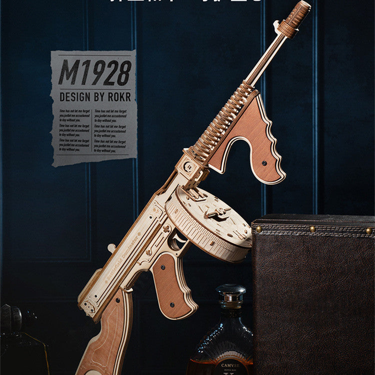 Wooden model of a rifle with 'M1928 Design by ROKR' text on a dark background.