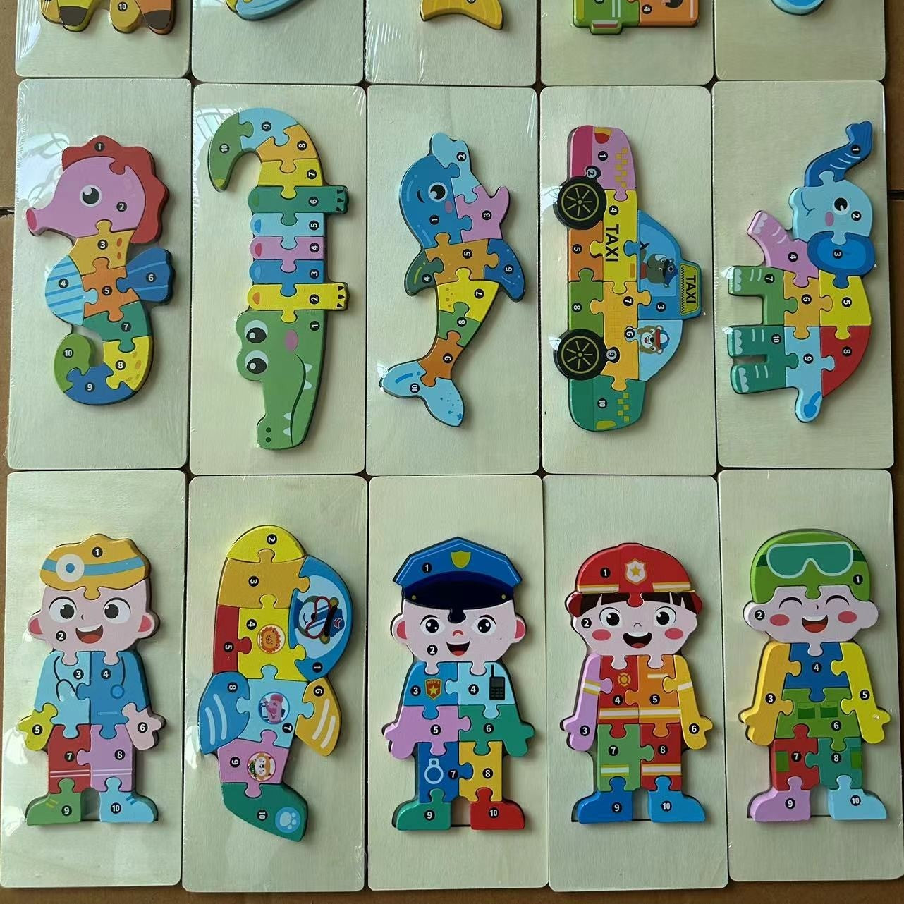 Colorful puzzle toys shaped like animals and characters on a white background