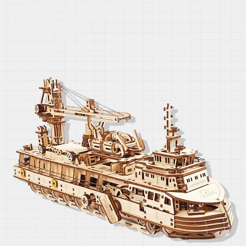 Wooden model ship with detailed structure on a white background