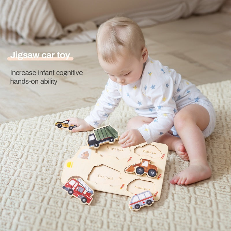 Baby playing with a wooden jigsaw car toy on a bed