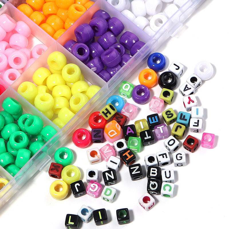 Colorful beads and letter beads in a clear container on a white background