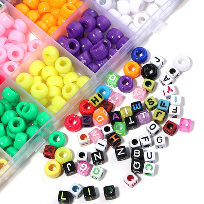 Colorful beads and letter beads in a clear container on a white background