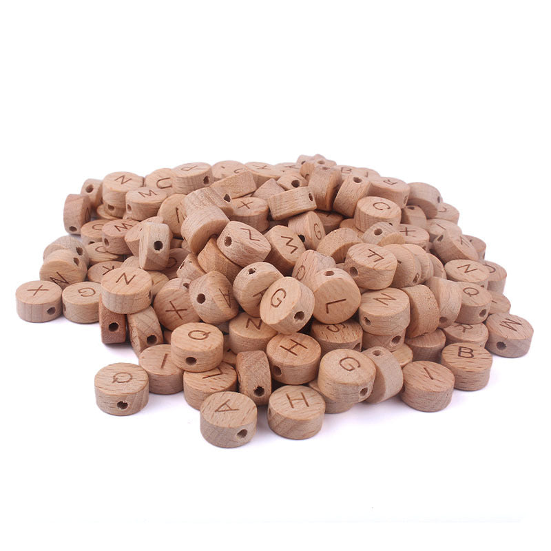 Pile of wooden letter beads on a white background