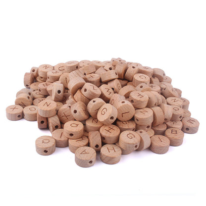 Pile of wooden letter beads on a white background