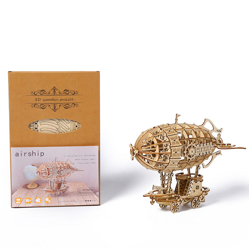 Wooden airship model puzzle with packaging on a white background