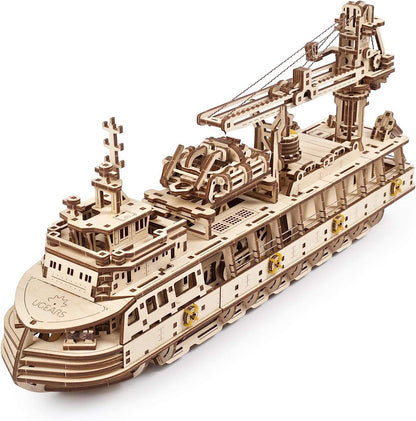 Wooden model ship with detailed structure on a white background